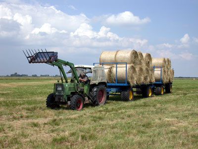Trailer with wide tyres used to remove bales of hay from wet areas