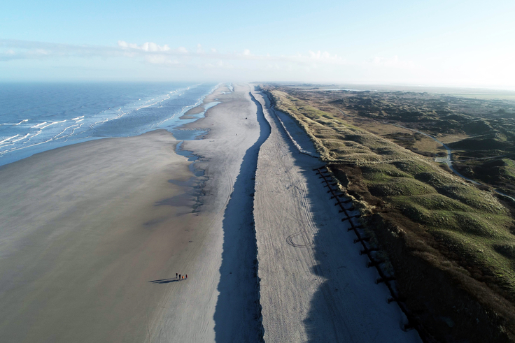 Am Sanddepot vor dem Pirolatal hat sich seit der letzten Strandaufspülung eine Abbruchkante gebildet, die sich kontinuierlich Richtung Schutzdüne bewegt. Der NLWKN überwacht u.a. aus der Luft die Entwicklung (Bild: NLWKN)